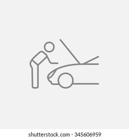 Man fixing car line icon for web, mobile and infographics. Vector dark grey icon isolated on light grey background.