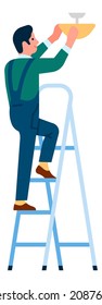 Man fixing light standing on stairs. Handyman repairing electrical thing
