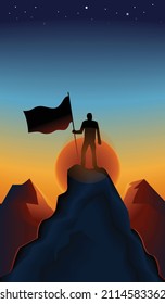 A man with flag wave at the top of a mountain. Top of a rock. Success concept. Sunset.