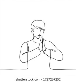 The man folded his hands together at chest level. The concept of reassurance, prayers to someone, attempts to concentrate, a pose from yoga, meditation. One continuous line drawing of a man meditating