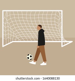 A man with a football ball on the background of a football goal