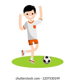 Man football player on the field. The guy in professional red sportswear. Boy playing ball on the grass. An active lifestyle.
