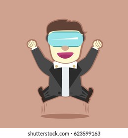 The man in the formal dress coat jumps up with joy and clenching his fists. He wears virtual reality glasses