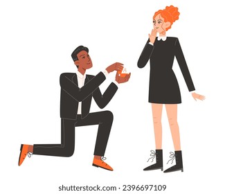 A man gets down on one knee and proposes to a woman
