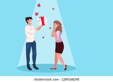 man giving woman gift box wrapped surprise happy valentines day holiday celebration concept couple in love over heart shapes female male full length characters horizontal