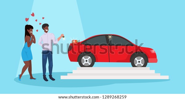 man giving woman\
keys to new car happy valentines day holiday concept african\
american couple in love over red heart shapes female male full\
length characters horizontal\
flat
