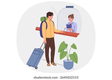 Man goes through passport control at airport crossing state border, showing documents to controller. Tourist with luggage or emigrant at passport control and checking visa permitting stay in country