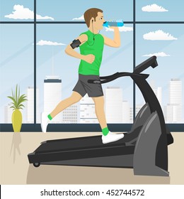 man at gym doing exercise on the treadmill with smartphone armband drinking water