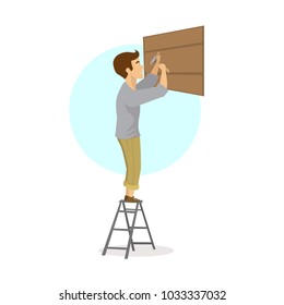 man hammering nail in wood plank, reparing constructing building