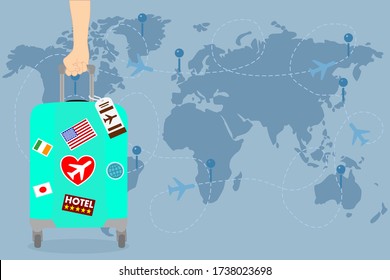 man hand is holding a blue Travel bag with sticker on the world map and has airplane. Vacation time around the world. Enjoy international trip . Tourism, Journey concept. 