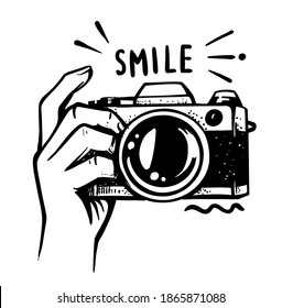 Man hand holding camera on white background. Female making photos with phrase. Black doodle for print t-shirt, package, web page, photography school, equipment store