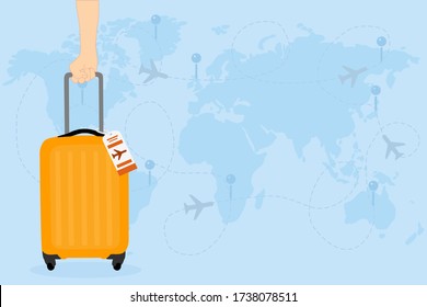 man hand is holding an Orange​ Travel bag with airline tag on the world map and has airplane. Vacation time around the world. 