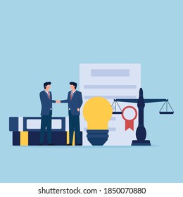 Man handshake in front of bulb, certificate and scales of justice metaphor of patent law.