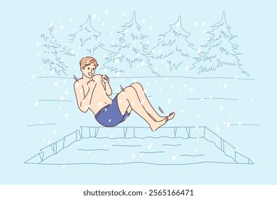 Man hardens himself by swimming in cold winter pond, jumping into icy water during snowfall. Guy hardens in forest bath to improve immunity and get ideal health helping to avoid colds and flu