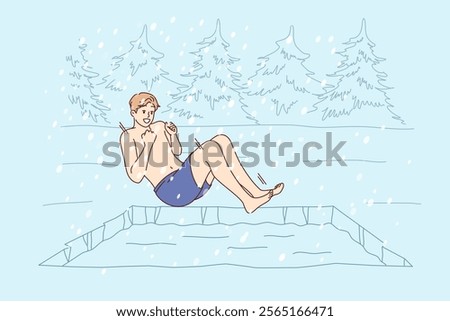 Man hardens himself by swimming in cold winter pond, jumping into icy water during snowfall. Guy hardens in forest bath to improve immunity and get ideal health helping to avoid colds and flu