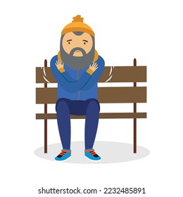 A man in a hat is freezing while sitting on a bench