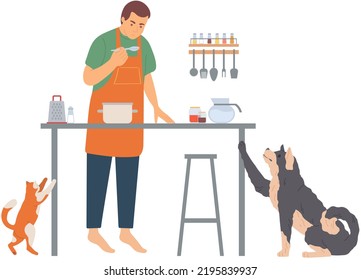 Man having breakfast or preparing lunch at kitchen room with his pet in morning. Friendship with your domestic animals cute cat and dog. Doggy asking for food from his owner. Pet care concept