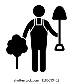 Man having digging equipment in hand and standing near the plant characterized as a gardner 