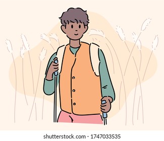 A man is hiking a reed with a backpack. hand drawn style vector design illustrations. 