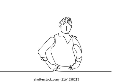 A man with his hands on his hips is deep in thought. a man with rolled up shirt sleeves