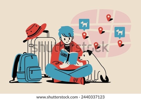A man and his pet looking at a guidebook map while traveling