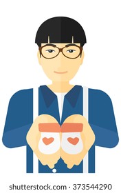Man holding baby booties.