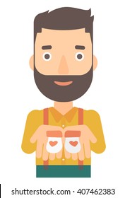 Man holding baby booties.