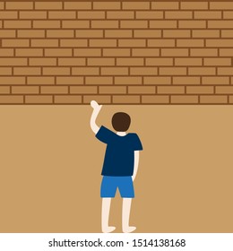 Man holding brick wall with one hand