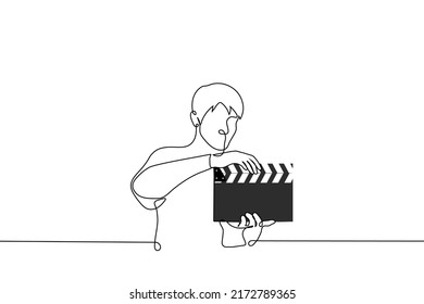 man holding clapperboard - one line drawing vector. filming process concept
