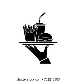 Man is holding fast food on tray. Service in cafe fast food black icon. Waiter delivers hamburger, fries, drink soda. Vector illustration flat design. Takeaway silhouette.
