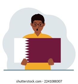 A man is holding the flag of Qatar in his hands. The concept of demonstration, national holiday or patriotism. Nationality. Vector flat illustration