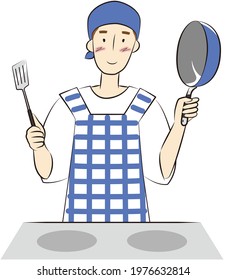 Man holding a frying pan and a turner in front of the stove