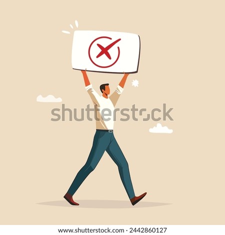 A man holding a green wrong no (check mark ) sign.