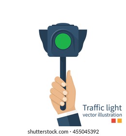 Man holding in hands traffic light, concept. Traffic policeman indicates green light. Vector illustration of a flat design. 