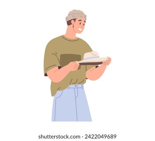 Man holding hat standing isolated on white. Customer choosing garments in mens clothing store. Male buyer buys headdress during shopping. Purchaser service in mall. Clothing and garment care concept