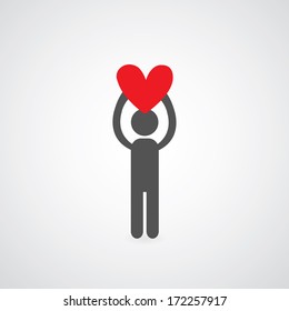 man holding heart symbol on gray background