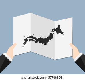 Man Holding a Japan Map 