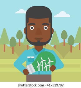 Man holding lightbulb with windmills inside.