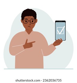 A man is holding a phone with a check mark on the screen. The concept of choice, voting or defence.
