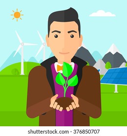 Man holding plant.