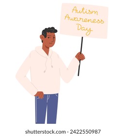 A man holding a poster for Autism Awareness Day