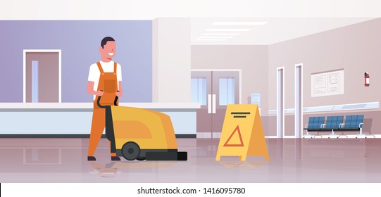 Man Holding Professional Washing Machine Male Cleaner Janitor In Uniform Cleaning Service Floor Care Concept Modern Hospital Waiting Hall Corridor Interior Horizontal Flat Full Length