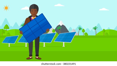 Man holding solar panel.