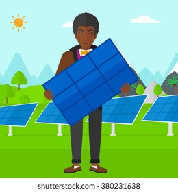 Man holding solar panel.