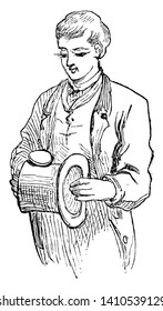 A man holding top hat in hands, vintage line drawing or engraving illustration