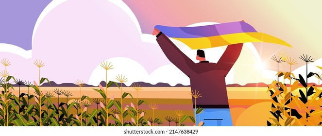 man holding Ukrainian flag outdoor pray for Ukraine peace save Ukraine from russia stop war concept