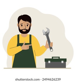 A man holds an adjustable wrench in his hand and a tool box next to it. The concept of technical repair or service.