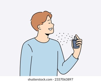 Man holds bottle of perfume and uses it before date with girl to exude good scent. Young guy in casual t-shirt closing eyes, applies perfume or deodorant to body to get rid of bad smell.