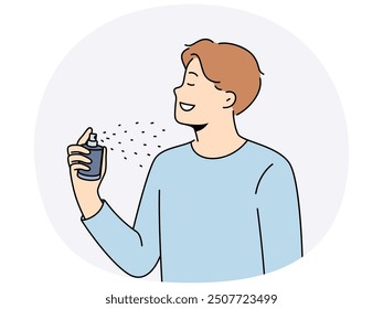 Man holds bottle of perfume and uses it before date with girl to exude good scent. Young guy in casual t-shirt closing eyes, applies perfume or deodorant to body to get rid of bad smell.