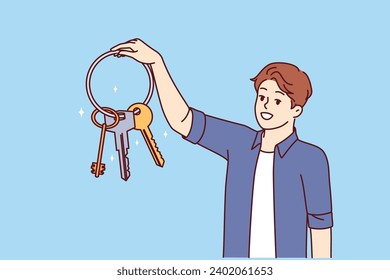 Man holds bunch of keys from entrance to house and garage or safe and smiles, feeling safety thanks presence of reliable locks. Owner of property shows off keys to doors to apartment